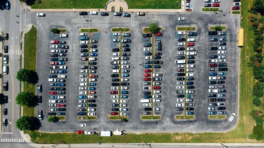 Aerial view of a university campus parking lot full of cars